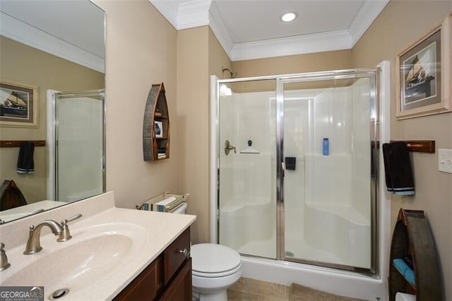 bathroom with vanity, a shower with door, ornamental molding, and toilet