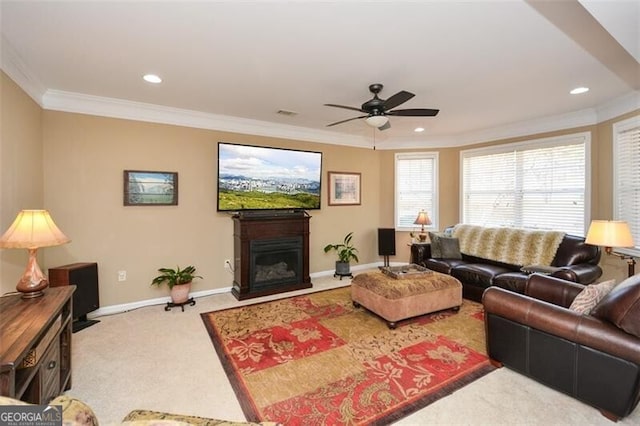 living room featuring crown molding, carpet floors, and ceiling fan