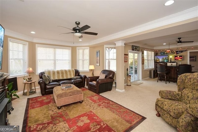 carpeted living room featuring crown molding, decorative columns, and ceiling fan