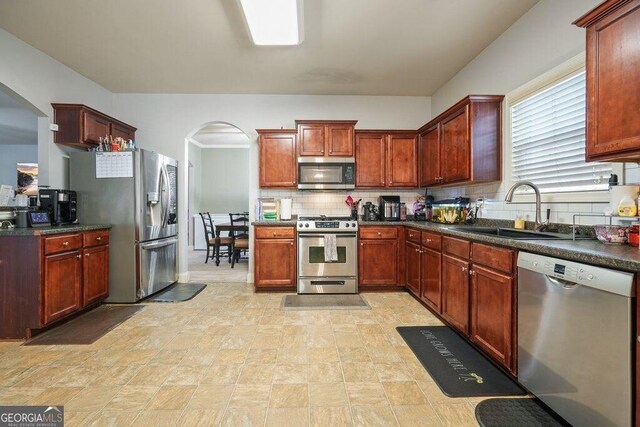 kitchen with stainless steel appliances, tasteful backsplash, and sink