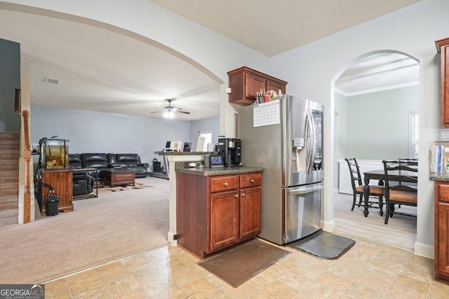 kitchen featuring light colored carpet, ceiling fan, and stainless steel refrigerator with ice dispenser