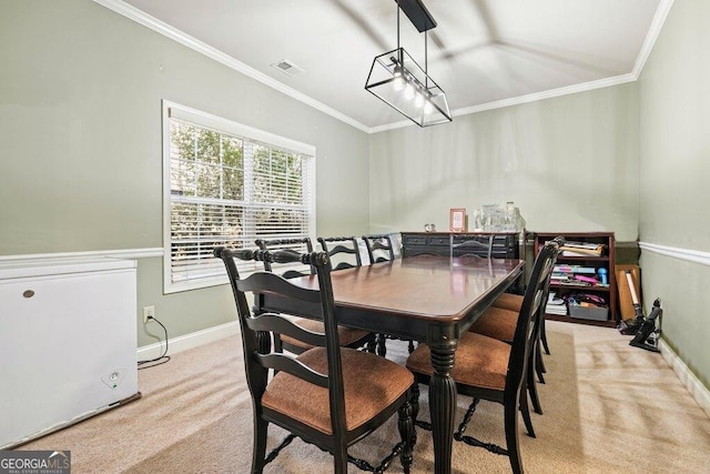 carpeted dining room with crown molding