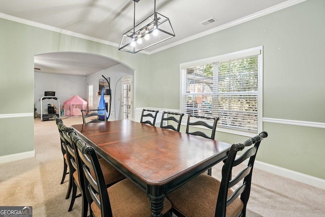 dining room featuring light carpet and ornamental molding