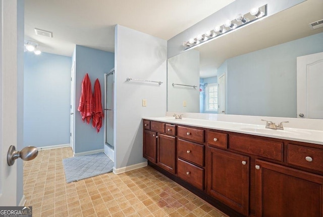 bathroom featuring vanity and an enclosed shower