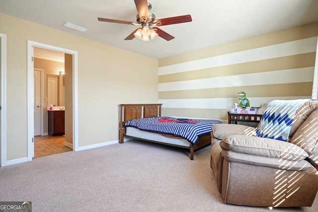 carpeted bedroom featuring ceiling fan and ensuite bathroom