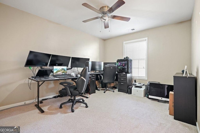 carpeted office space with ceiling fan