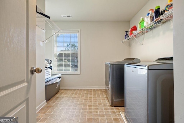 clothes washing area with washer and clothes dryer