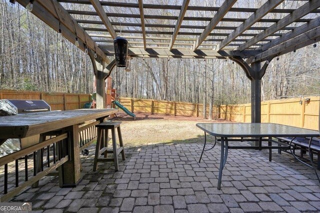 view of patio featuring grilling area and a pergola