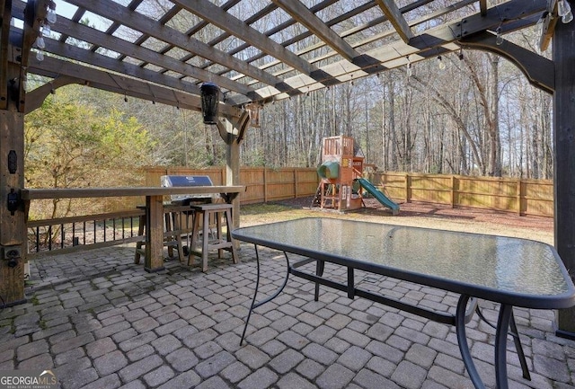 view of patio / terrace featuring a playground and a pergola