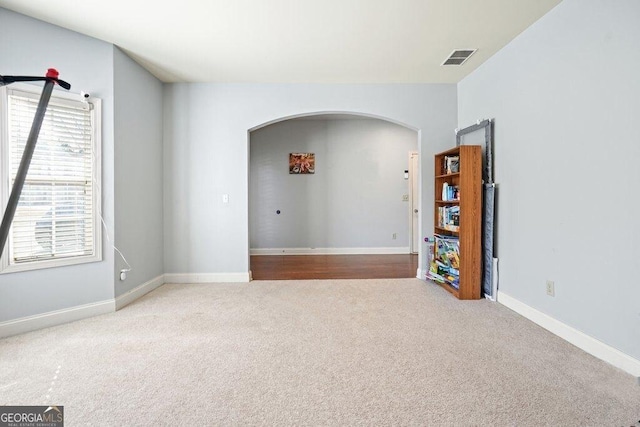 spare room featuring light carpet