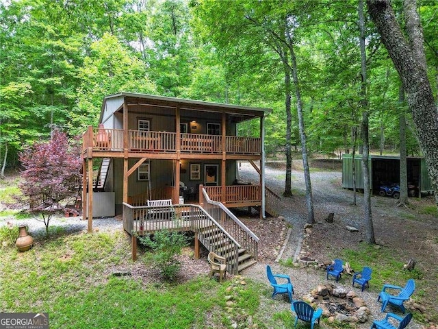 view of front of property with a deck and an outdoor fire pit