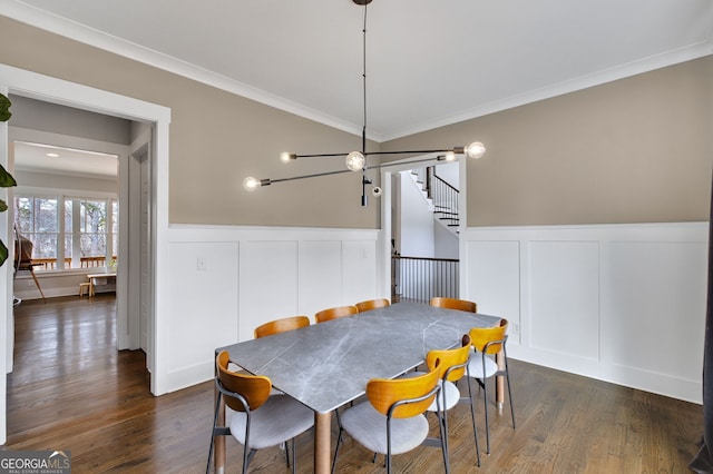 dining space featuring ornamental molding and dark wood-type flooring