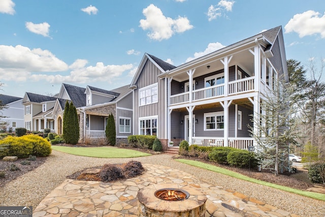 view of front of home featuring a balcony and a fire pit