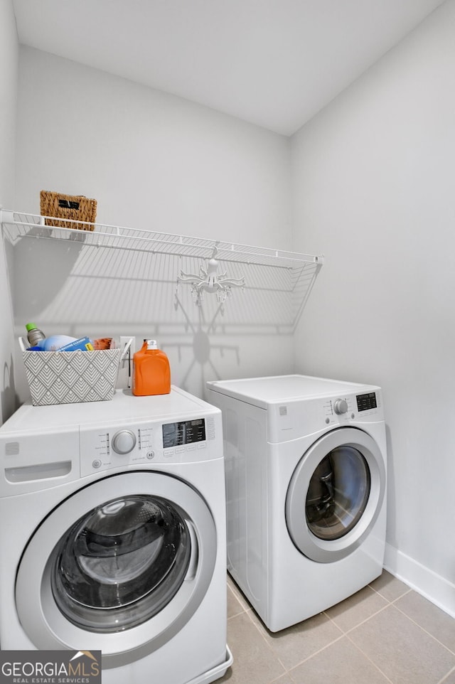 clothes washing area featuring light tile patterned floors and independent washer and dryer