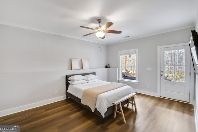 bedroom with dark wood-type flooring, ceiling fan, and ornamental molding