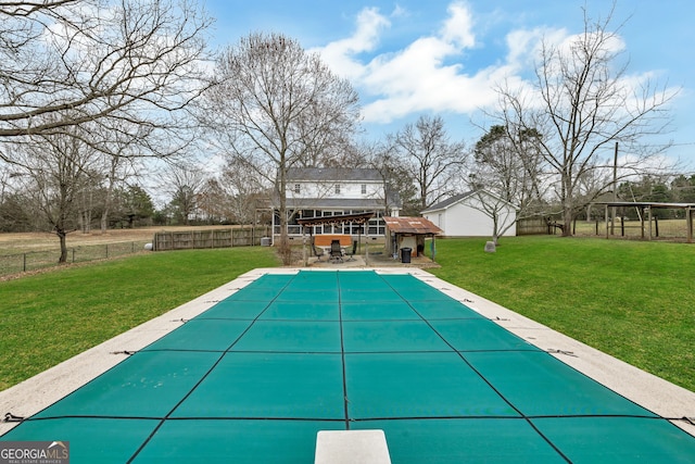 view of swimming pool with a yard, an outdoor structure, and a patio