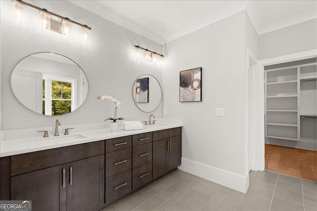 bathroom featuring vanity, crown molding, and tile patterned floors