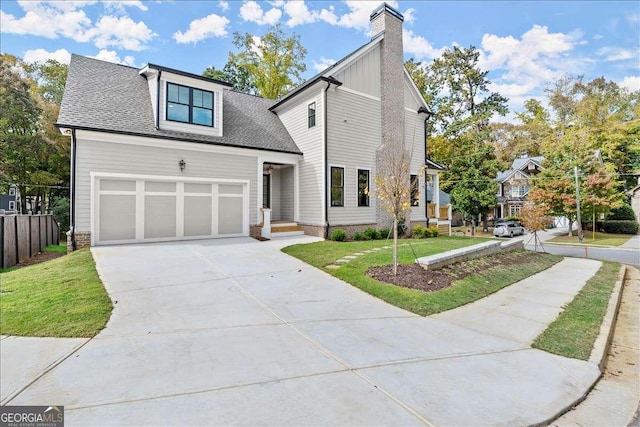 view of property featuring a garage and a front yard