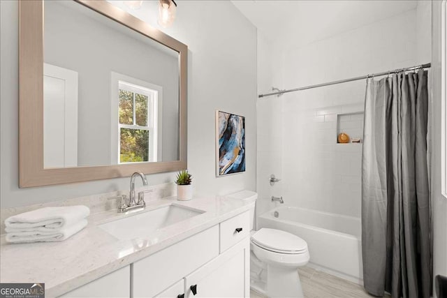 full bathroom featuring vanity, shower / bathtub combination with curtain, and toilet