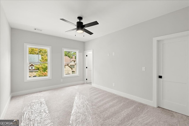 carpeted empty room with ceiling fan