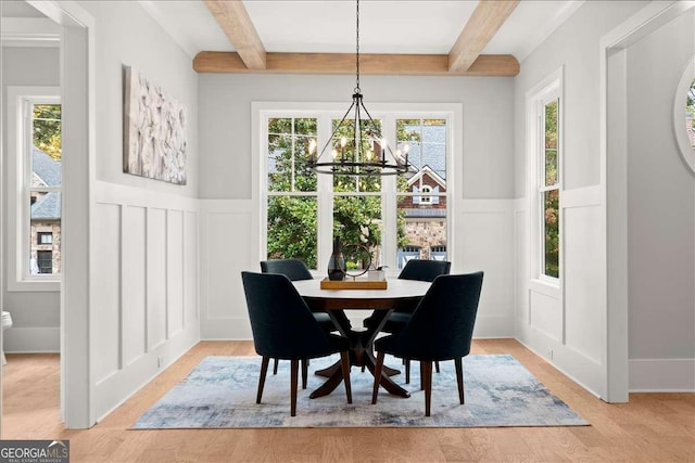 dining room featuring an inviting chandelier, beam ceiling, and a healthy amount of sunlight