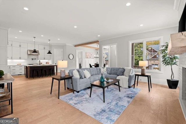 living room featuring a brick fireplace and light wood-type flooring