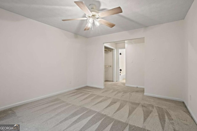 unfurnished room featuring light colored carpet and ceiling fan