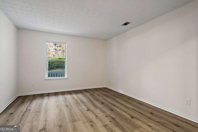 spare room with light hardwood / wood-style flooring