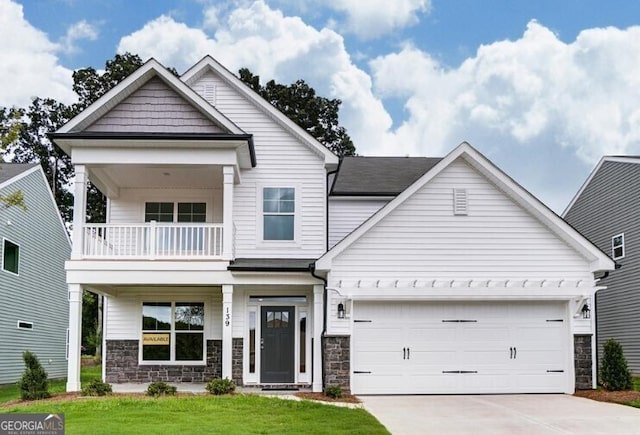 view of front of home with a garage, a front lawn, and a balcony