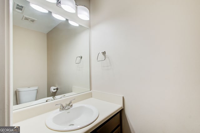 bathroom featuring vanity and toilet