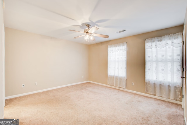 carpeted empty room with ceiling fan