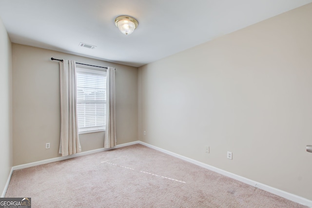 empty room featuring light carpet