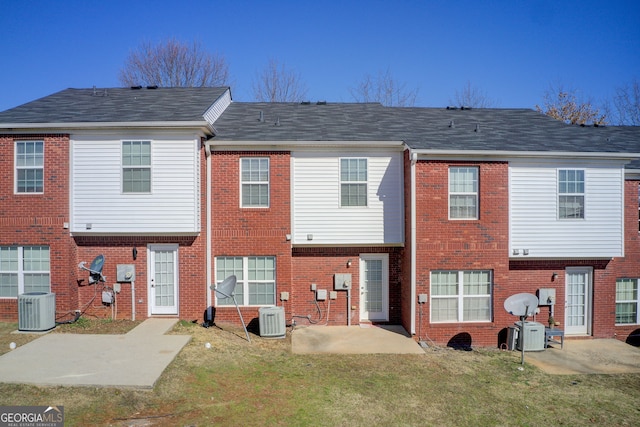 back of property featuring a patio, central AC, and a lawn