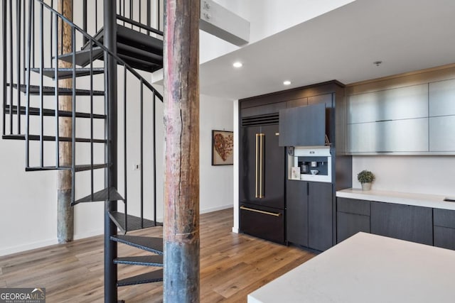 kitchen featuring built in fridge and light hardwood / wood-style flooring