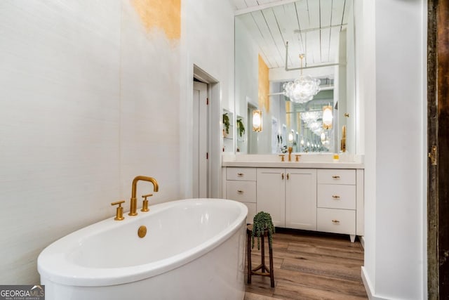 bathroom featuring wood-type flooring, a bathtub, and vanity