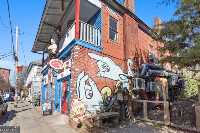 view of side of home featuring a balcony