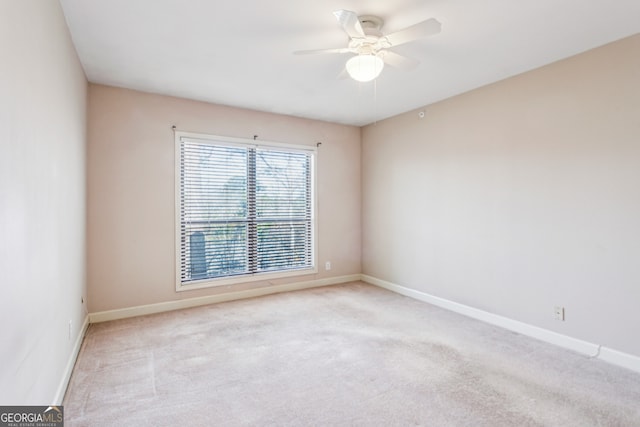 carpeted empty room with ceiling fan