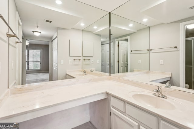 bathroom with vanity and toilet