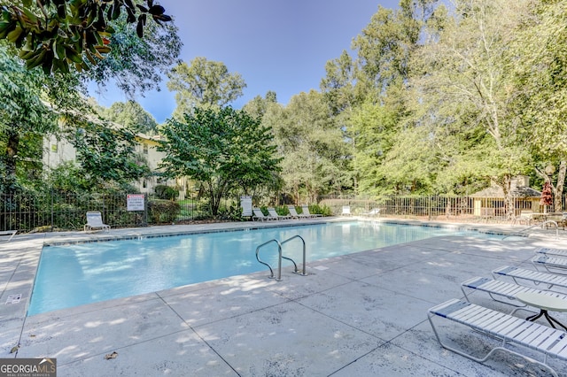 view of swimming pool with a patio