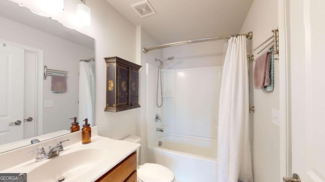 full bathroom with visible vents, shower / tub combo with curtain, vanity, and toilet