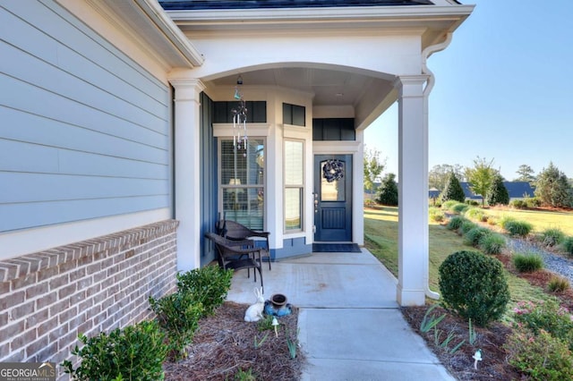 view of exterior entry featuring a porch