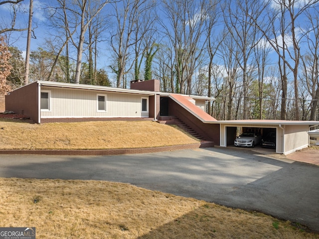 view of front of property with a carport and a front lawn