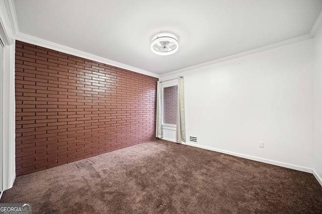 unfurnished room featuring crown molding, carpet, and brick wall