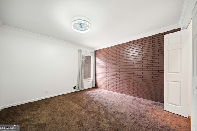 unfurnished bedroom featuring dark colored carpet, brick wall, and ornamental molding