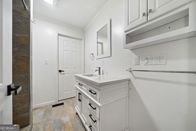 bathroom with vanity and ornamental molding