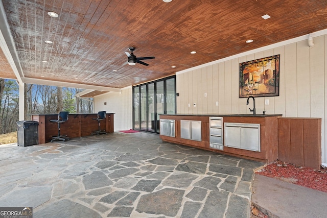 view of patio / terrace with sink, ceiling fan, and an outdoor kitchen