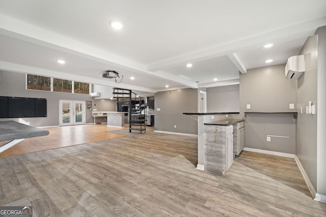 bar featuring beam ceiling, a wall mounted air conditioner, light hardwood / wood-style floors, and french doors