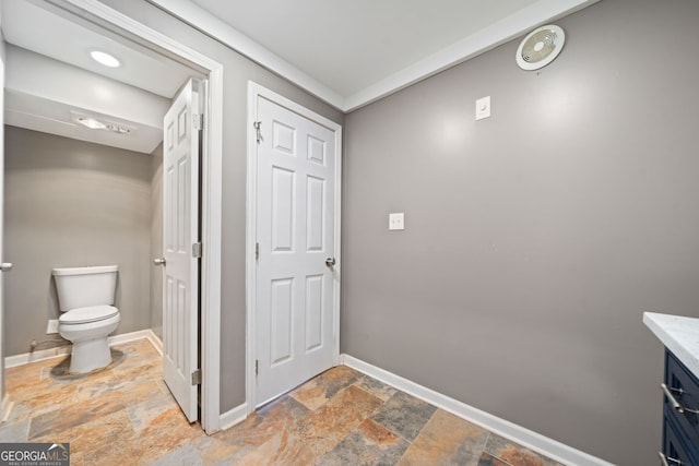 bathroom featuring vanity and toilet