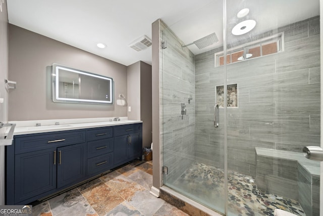 bathroom featuring vanity and a shower with shower door