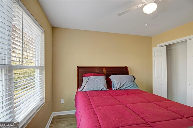 bedroom with wood-type flooring and ceiling fan